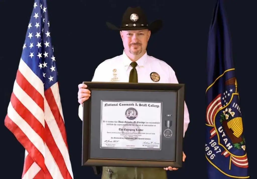 A person wearing a cowboy hat and sheriff's badge